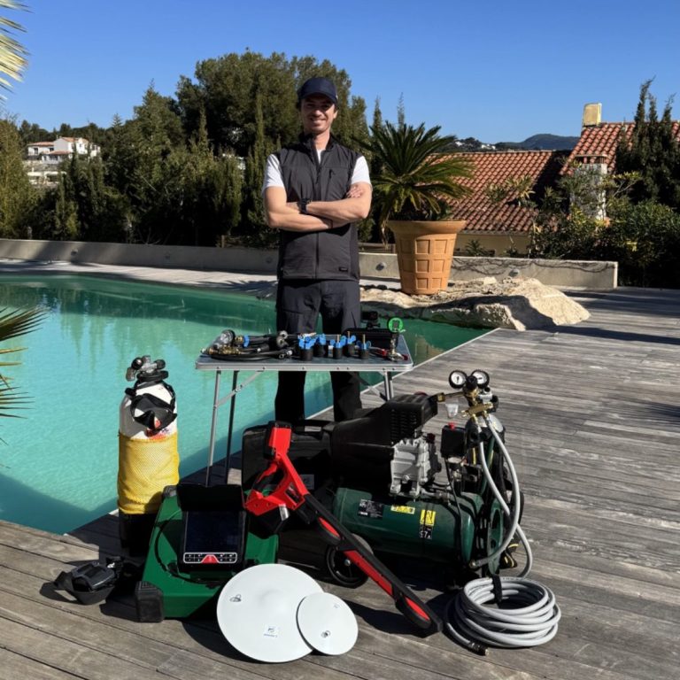 Homme à côté d'un équipement de plongée, d'un compresseur ainsi que du matériel dédié à la recherche de fuites près d'une piscine.